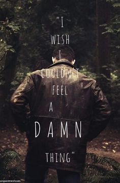 a man standing in the woods with his back turned to the camera and text that reads, i wish i couldn't feel a damn thing