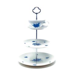 three tiered serving tray with blue and white designs