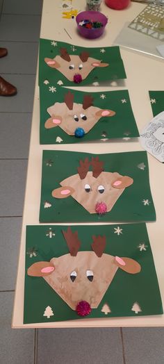 three paper plates with reindeers on them sitting on a table next to each other