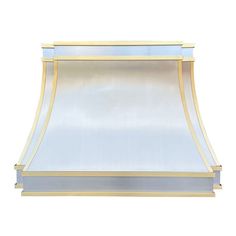 an image of a gold and white wall mounted range hood with blue trimmings