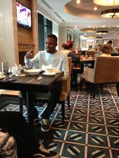 a man sitting at a table in a restaurant