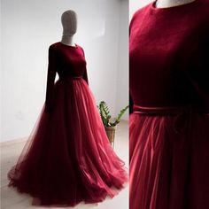 a red dress is on display in front of a mannequin