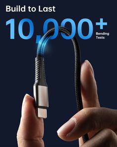 a hand holding a usb cable with the words build to last 10, 000 +