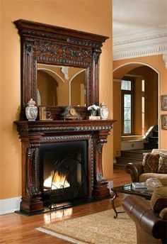 a living room filled with furniture and a fire place in the middle of a room