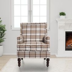 a chair sitting in front of a fireplace with a potted plant next to it