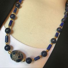 Lapis Lazuli, A Deep Blue Semi-Precious Stone, Has Been Prized Since Antiquity For Its Intense Color. Fashioned W/8mm Lapis Round Beads, Lapis Cylindrical Beads, Enhanced With Gold Plated Spacers, And To Top It Off The Beautiful Unique Design Handcrafted Large Bead Using Natural Lapis And Brass. Necklace Measures 28" Length. Lapis Lazuli Beads Imported From Afghanistan. Earrings Sold Separately. Designed & Artisan Handcrafted By Joluxxe Designs. Will Be Delivered In A Beautiful Gift Box. Traditional Blue Necklaces For Formal Occasions, Blue Lapis Lazuli Beaded Necklaces, Elegant Blue Lapis Lazuli Beaded Necklaces, Traditional Blue Necklace, Formal Blue Handmade Necklace, Formal Handmade Blue Necklace, Traditional Blue Lapis Lazuli Jewelry, Traditional Blue Lapis Lazuli Necklace, Lapis Lazuli Necklace