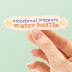 someone holding up a sticker with the words water bottle in it's left hand