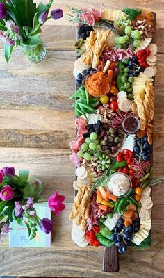 a wooden table topped with lots of different types of food