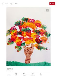 an image of a tree made out of paper and colored flowers on top of it