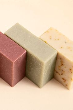 four different types of soaps lined up on a table