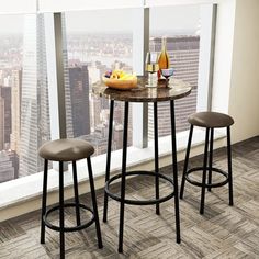 two stools and a table in front of a window overlooking the cityscape