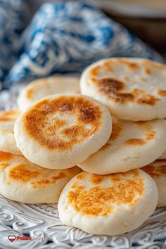 some food is on a plate with blue and white napkins in the back ground