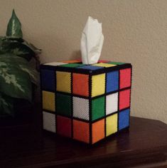 a tissue dispenser made out of rubikt cubes on a table