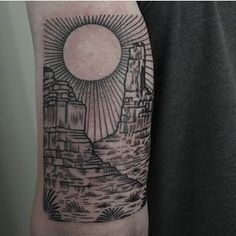 a man's arm with a black and white tattoo on it, depicting a cityscape