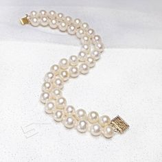 8-9mm freshwater pearls with a fine 14KT yellow gold filled clasp 2 rows bracelet. High quality cultured pearls with good luster and less blemish, hand knoteed between each pearl. It is a perfect gift for Anniversary, Birthday, Engagement, Wedding, Mother's day, Valentine's day or just a reward for yourself. Quality: AA+ Color : Natural White Luster: Highest sheen and luster Nacre: lustrous and thick nacre Blemish: 92% - 96% Clear Shape : Near round -Round Size: 8-9 mm approx. Total length: 7.5 Real Pearl Jewelry, Real Pearl Jewellery, Round Round, Pearl Bangle, Real Pearls, Cultured Pearls, Engagement Wedding, Pearl Bracelet, Pearl Jewelry