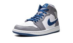 The Air Jordan 1 Mid “Cement Grey/True Blue” is a neutral colorway of the popular lifestyle shoe that was released in 2022.  Appearing in “Cement Grey/True Blue,” the Jordan 1 Mid is complete with a white leather base with contrasting Cement Grey leather overlay panels.  A True Blue leather Swoosh is located on either side of the shoe and a white “Wings” logo is found on the collar.  Jumpman and “Air” detailing appears on the blue nylon tongue tag.  A white rubber midsole and blue outsole comple Jordan 1 Gray And Blue, Jordan 1 Gray, Blue Mens Shoes, Cement Gray, White Wings, Wings Logo, Stadium Goods, Air Jordan 1 Mid, Jordan 1 Mid