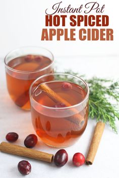 two glasses filled with hot spiced apple cider