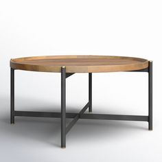 an oval wooden table with metal legs and a circular tray on the bottom that has been turned into a coffee table