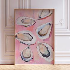 an abstract painting of oysters on a pink background in a room with white walls