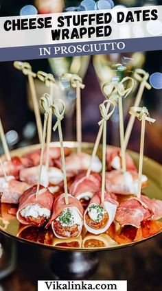 a platter filled with appetizers and cheese wrapped in prosciutto