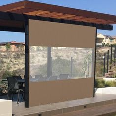 an outdoor covered patio area with chairs and tables