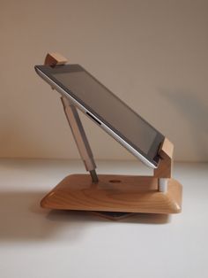 a cell phone is sitting on top of a wooden stand that holds it's screen