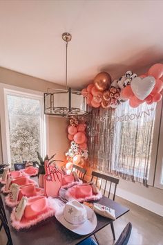 pink balloons, rose gold balloons, cowprint balloons, balloon arch over window in kitchen, kitchen table with hangover kits, feather cowgirl hats, foam finger and bride cowgirl hat, last hoedown bachelorette party, bachelorette weekend in Nashville Cowgirl Hats Bachelorette, Cowgirl Bachelorette Party Favors, Cowgirl Themed Bachelorette Party, Last Hoedown, Cowgirl Bachelorette Party Outfits, Bach Party Decorations, Music Line, Country Bachelorette Parties, Country Bachelorette