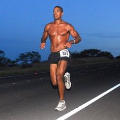 a man running on the road at night