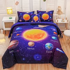 a bed room with a neatly made bed covered in space themed sheets and pillow cases