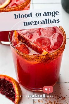 blood orange mezcaltass in a glass with a sign on the side