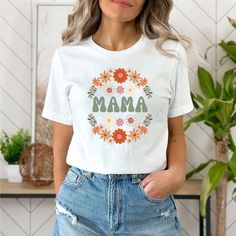 The perfect shirt for any Mama or Mama to be! sizes- small - 3XL This classic unisex jersey short sleeve tee fits like a well-loved favorite. Soft cotton and quality print make users fall in love with it over and over again. These t-shirts have-ribbed knit collars to bolster shaping. The shoulders have taping for better fit over time. Dual side seams hold the garment's shape for longer.  .: 100% Airlume combed and ringspun cotton (fiber content may vary for different colors) .: Light fabric (4.2 oz/yd² (142 g/m .: Retail fit .: Tear away label .: Runs true to size Mother's Day Shirt With Custom Print And Relaxed Fit, Relaxed Fit Shirt With Custom Print For Mother's Day, Mother's Day Floral Print Short Sleeve Top, Floral Print Short Sleeve Top For Mother's Day, Funny Print Short Sleeve Shirt For Mother's Day, Mother's Day Short Sleeve Shirt With Custom Print, Relaxed Fit Custom Print T-shirt For Mother's Day, Floral Print Short Sleeve Top, Mother's Day Floral Print Crew Neck T-shirt