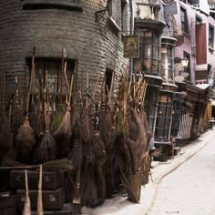 an alleyway with lots of old buildings and brooms