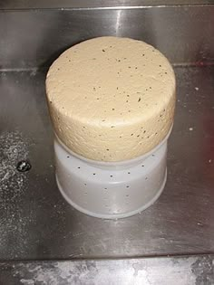 a round cake sitting on top of a metal counter