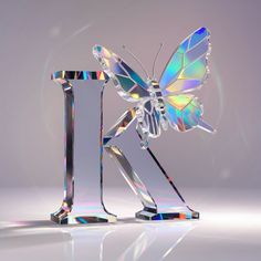 a glass sculpture with a butterfly on it's back legs and the letter k