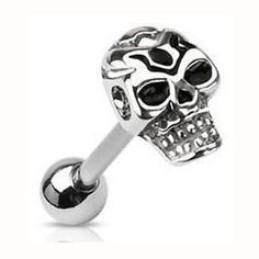 a silver skull piercing ring with black stones on the top and an eyeball in the middle