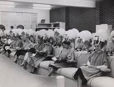 several women sitting on couches with helmets on their heads and books in front of them