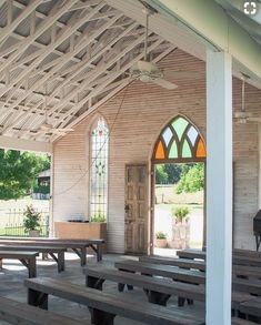 the inside of an old church with benches and stained glass windows on the front door