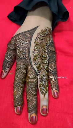 the hand and foot of a woman with henna on it