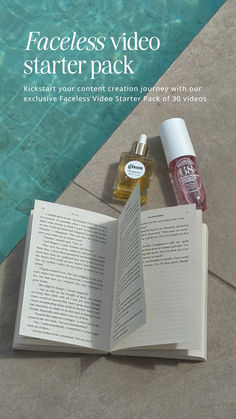 an open book sitting on top of a table next to a bottle of water and perfume