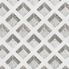 a white and grey tiled wall with diamond shapes