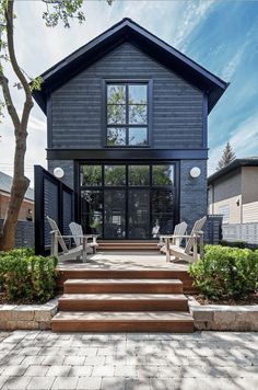 a black house with steps leading up to the front door