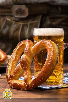 two pretzels and a mug of beer on a table