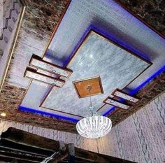 a chandelier hanging from the ceiling in a room with marble walls and ceilings