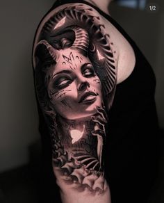 a woman's arm with a black and white tattoo design on her left shoulder