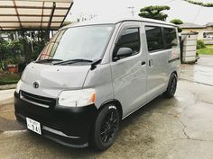 a gray van parked in front of a house