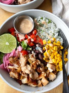 two bowls filled with different types of food on top of a wooden table next to each other