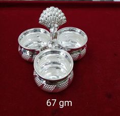 three silver dishes on a red velvet surface with measurements for the size and width in front