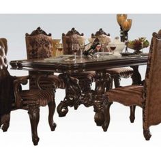 a dining room table with chairs and plates on it