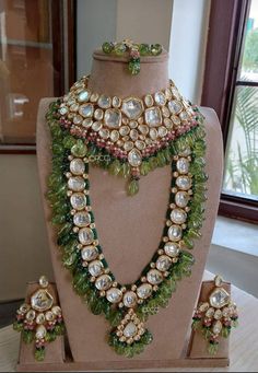 an elaborate necklace and matching earrings on display