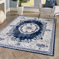 a blue and white area rug in a living room